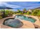 Stunning pool and spa combination with lush landscaping, offering a private retreat for relaxation and outdoor entertainment at 31900 N 127Th Ln, Peoria, AZ 85383