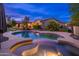 A beautiful swimming pool and hot tub create a serene backyard oasis at 31900 N 127Th Ln, Peoria, AZ 85383