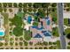 Aerial view of a luxurious home with a sparkling pool, patio, and expansive solar panel roof at 3410 E Inglewood Cir, Mesa, AZ 85213