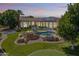 Expansive backyard with a rock feature pool, putting green, trampoline, and desert landscaping at 3410 E Inglewood Cir, Mesa, AZ 85213
