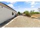 Spacious gravel backyard featuring a gated entrance and a well-maintained landscape at 3410 E Inglewood Cir, Mesa, AZ 85213