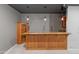 Basement bar area with wood cabinets, marble countertops, pendant lighting and a classic display cabinet for all your glassware at 3410 E Inglewood Cir, Mesa, AZ 85213