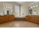 Bathroom featuring double sinks, a soaking tub with glass block window, and tile flooring at 3410 E Inglewood Cir, Mesa, AZ 85213
