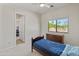 Cozy bedroom with a twin bed, carpeted floors, and a window with natural light at 3410 E Inglewood Cir, Mesa, AZ 85213