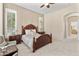 Comfortable bedroom with carpet, a four-poster bed, side tables, and natural light from windows with plantation shutters at 3410 E Inglewood Cir, Mesa, AZ 85213