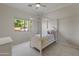 Well-lit bedroom features a four-poster bed, carpet flooring, a ceiling fan and a window view of trees at 3410 E Inglewood Cir, Mesa, AZ 85213