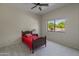 This bedroom features a ceiling fan and a window with a view of lush landscaping at 3410 E Inglewood Cir, Mesa, AZ 85213