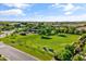 Aerial view of a sprawling community park with lush greenery, a playground, and shaded picnic areas at 3410 E Inglewood Cir, Mesa, AZ 85213