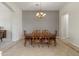 Formal dining room with ornate wood table, chairs, and a decorative chandelier at 3410 E Inglewood Cir, Mesa, AZ 85213