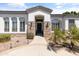 Close up of the front entrance with beautiful stonework and desert landscaping at 3410 E Inglewood Cir, Mesa, AZ 85213
