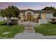 Charming home featuring a well-manicured lawn, inviting walkway, and stone accents at 3410 E Inglewood Cir, Mesa, AZ 85213