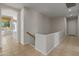 Hallway featuring tile flooring, natural light and a wooden railing at 3410 E Inglewood Cir, Mesa, AZ 85213