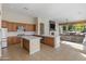 Bright kitchen with an island, stainless steel appliances, tile floors, and a view into the Gathering room at 3410 E Inglewood Cir, Mesa, AZ 85213