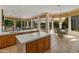 Spacious kitchen with large island, tile floors, and a view of the pool at 3410 E Inglewood Cir, Mesa, AZ 85213