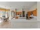 Open kitchen with island, dining area, tile floors, and backyard views at 3410 E Inglewood Cir, Mesa, AZ 85213