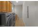 Efficient laundry room with modern washer and dryer set and ample cabinet storage at 3410 E Inglewood Cir, Mesa, AZ 85213