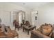 Comfortable living room with leather furniture, a piano, and arched entryways at 3410 E Inglewood Cir, Mesa, AZ 85213