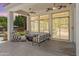 Covered patio featuring a stylish lounge area, ceiling fans, tile flooring, and views of the gorgeous backyard and pool at 3410 E Inglewood Cir, Mesa, AZ 85213