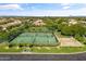 Overhead shot showcases tennis and basketball courts, enhanced by picturesque surroundings and lush greenery at 3410 E Inglewood Cir, Mesa, AZ 85213