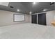 Large theater room with a dark ceiling, projector screen, and plush carpet at 3410 E Inglewood Cir, Mesa, AZ 85213