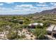 Expansive aerial view of desert community homes, swimming pools, and mature landscaping with mountain views in the background at 34221 N Boulders Pkwy, Scottsdale, AZ 85266
