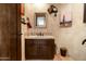 Stylish powder room featuring a Southwestern aesthetic, custom mirror, sink, and decor at 34221 N Boulders Pkwy, Scottsdale, AZ 85266