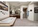 Bright bathroom featuring a soaking tub and a tiled walk-in shower at 34221 N Boulders Pkwy, Scottsdale, AZ 85266