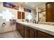 Bathroom features large mirrors, and tile counters with tiled shower at 34221 N Boulders Pkwy, Scottsdale, AZ 85266