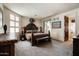 Well-lit bedroom showcasing southwest inspired decor and plush carpeting at 34221 N Boulders Pkwy, Scottsdale, AZ 85266