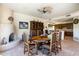 Cozy dining area with a unique fireplace, custom wood dining table, and views to the kitchen at 34221 N Boulders Pkwy, Scottsdale, AZ 85266