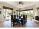 Sun-filled dining room boasts backyard views and a Southwestern-style fireplace, adding a rustic touch at 34221 N Boulders Pkwy, Scottsdale, AZ 85266