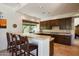 Classic kitchen with wood cabinets, tile countertops, breakfast bar, and desert view at 34221 N Boulders Pkwy, Scottsdale, AZ 85266