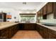 Spacious kitchen with wooden cabinets, tile countertops, breakfast bar, and large view window at 34221 N Boulders Pkwy, Scottsdale, AZ 85266
