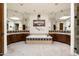 Luxurious bathroom featuring dual vanities, a soaking tub, decorative tiling, and plenty of space at 34221 N Boulders Pkwy, Scottsdale, AZ 85266