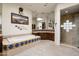 Large main bathroom offering dual vanities, a soaking tub, shower, and decorative mirrors at 34221 N Boulders Pkwy, Scottsdale, AZ 85266