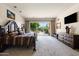 Relaxing primary bedroom featuring patio access and plush carpeting, creating a cozy retreat at 34221 N Boulders Pkwy, Scottsdale, AZ 85266