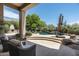Backyard pool area with ample seating and outdoor fireplace at 34221 N Boulders Pkwy, Scottsdale, AZ 85266