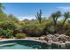 Backyard pool with desert landscaping and mountain views at 34221 N Boulders Pkwy, Scottsdale, AZ 85266