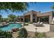 Inviting backyard pool and patio area perfect for relaxing and entertaining with desert landscape at 34221 N Boulders Pkwy, Scottsdale, AZ 85266