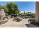 Backyard pool area with two lounge chairs and outdoor kitchen at 34221 N Boulders Pkwy, Scottsdale, AZ 85266