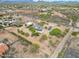 Rural home with solar panels sits on a large desert property with several outbuildings at 37414 N 17Th Ave, Phoenix, AZ 85086