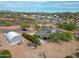 An aerial shot of a rural home with several outbuildings, mature landscape and desert vegetation at 37414 N 17Th Ave, Phoenix, AZ 85086