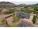 A closer view of the home, showing the modern design with unique window elements, solar panels, and surrounding landscape at 37414 N 17Th Ave, Phoenix, AZ 85086