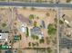Wide angle aerial shot of the property showing the home surrounded by desert landscape and bordering neighborhood homes at 37414 N 17Th Ave, Phoenix, AZ 85086