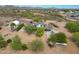 An aerial shot of the home and acreage featuring mature desert trees, with a vehicle shelter in the backyard at 37414 N 17Th Ave, Phoenix, AZ 85086