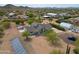 Home with solar panels and desert landscaping featuring multiple sheds and shop buildings at 37414 N 17Th Ave, Phoenix, AZ 85086
