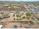 Expansive aerial view of a desert home with a pool, large garage, solar panels and mountain views at 37414 N 17Th Ave, Phoenix, AZ 85086