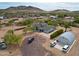 Birds eye view of desert home with a circular metal storage unit and multiple cars at 37414 N 17Th Ave, Phoenix, AZ 85086