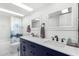 Elegant bathroom featuring dual sinks, modern fixtures, and a shower-tub combination at 37414 N 17Th Ave, Phoenix, AZ 85086