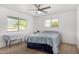 Bright bedroom with a ceiling fan, carpet, and two windows at 37414 N 17Th Ave, Phoenix, AZ 85086